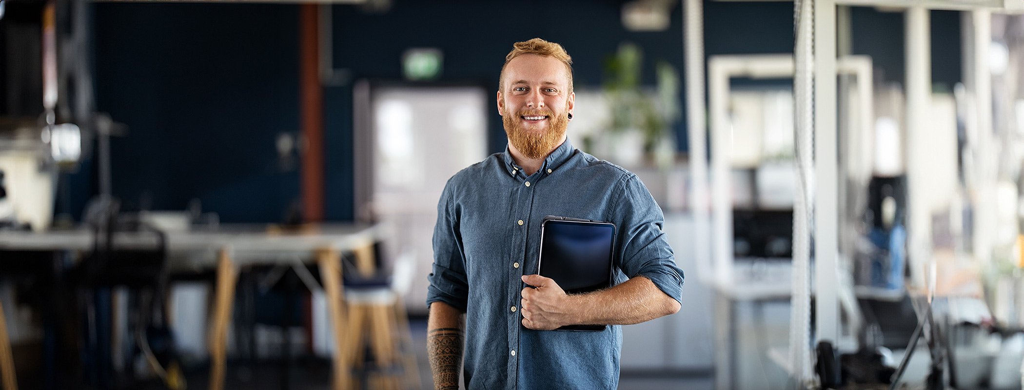 Technical-guy-happy-with-tablet-under-arm-HERO